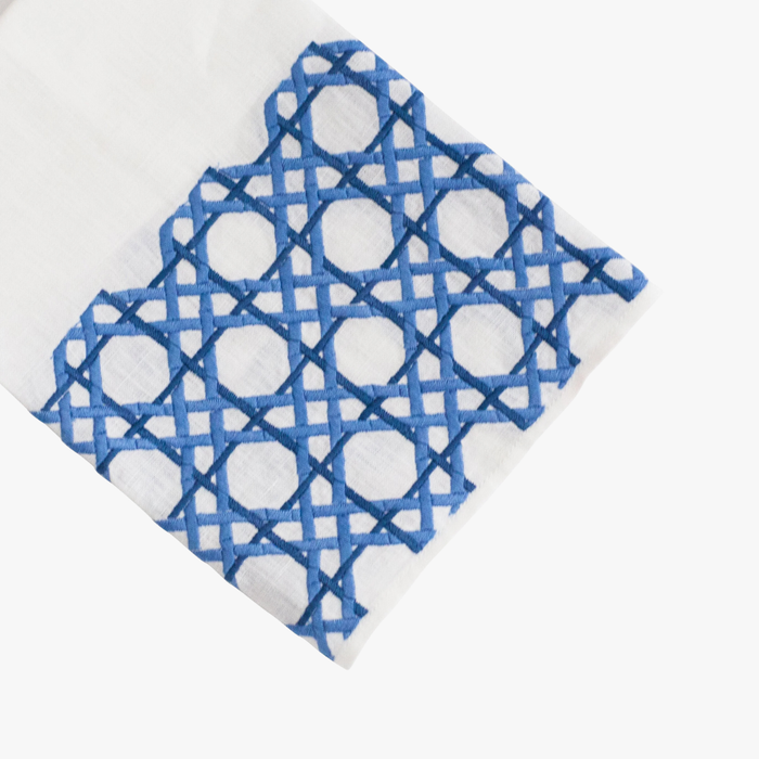 Whitelinen  tip towel with blue geometric pattern on a white background
