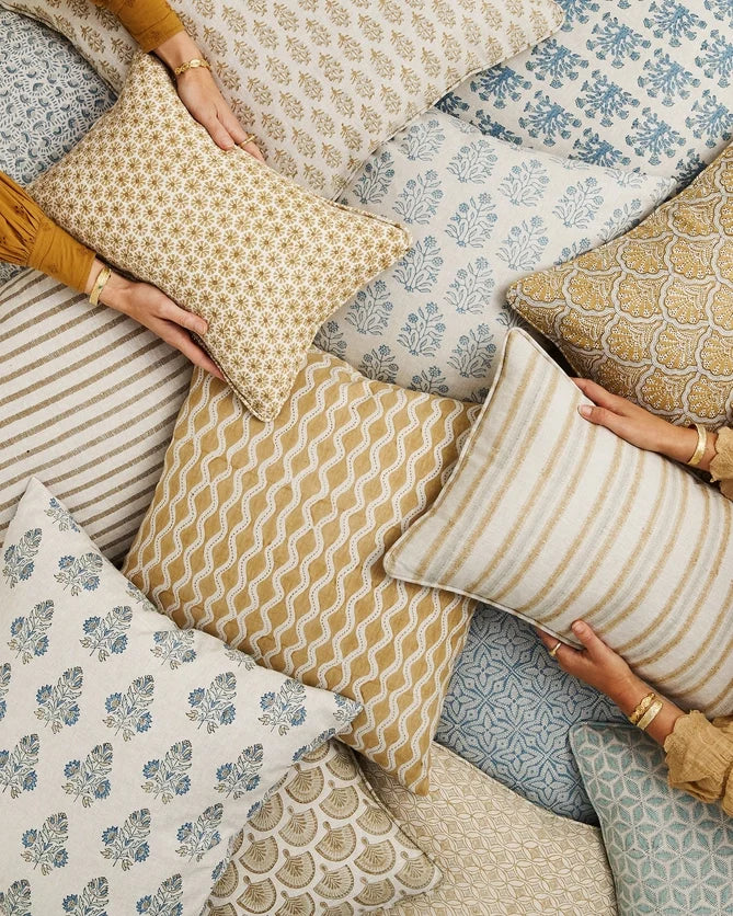 Etoile Saffron Lumbar Pillow Cover in pile of block print pillows