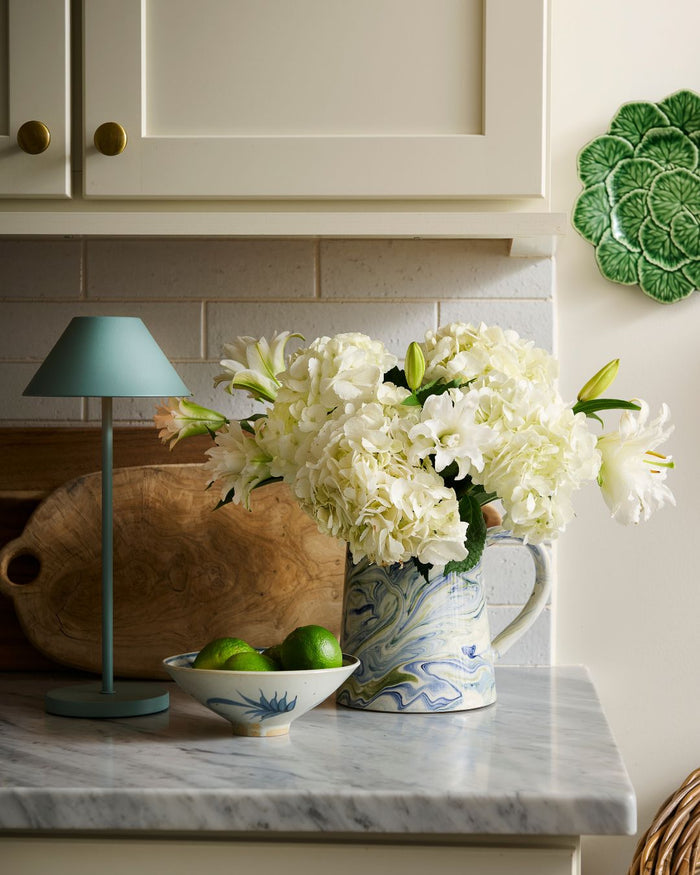 Marbled Ocean Pitcher styled in kitchen with white flowers