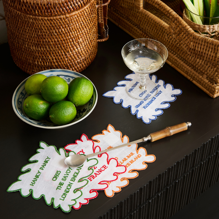 Mixed Drink Cocktail Napkin Set styled on bar cart with rattan accessories