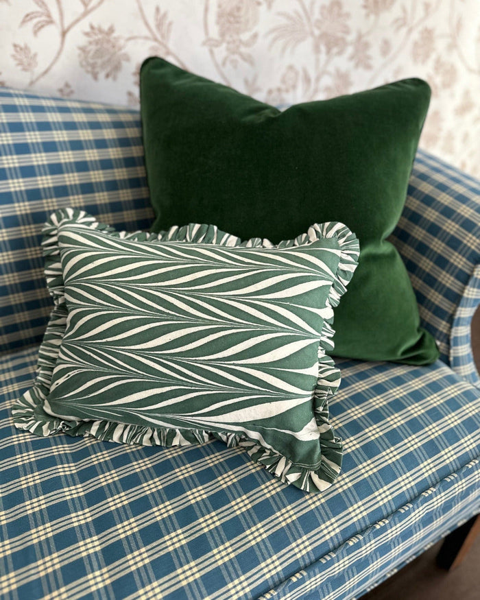 Moss Velvet Pillow styled with green chevron ruffle lumbar