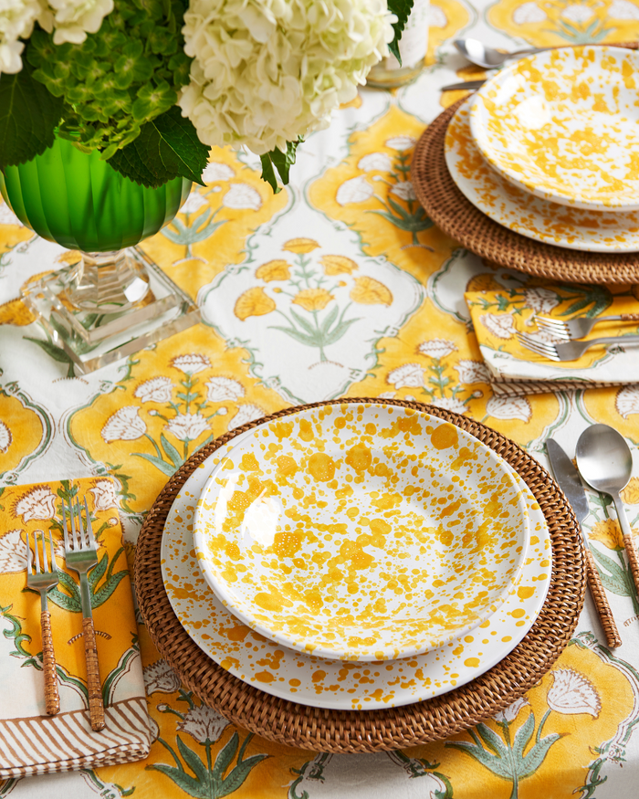 Sunny Days Napkin and Tablecloth styled with yellow splatter dinnerware