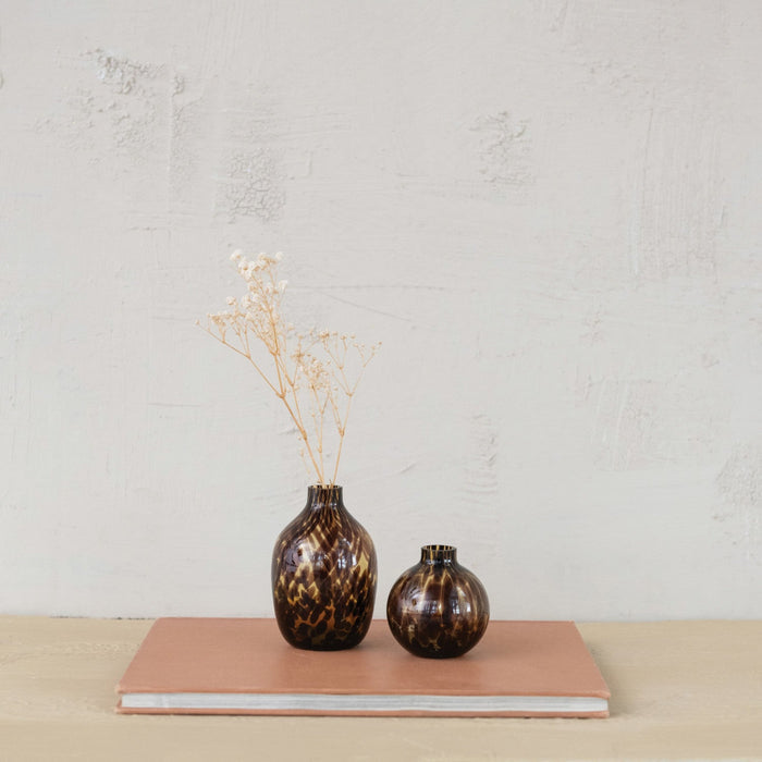 Tortoise Glass Bud Vase set on book