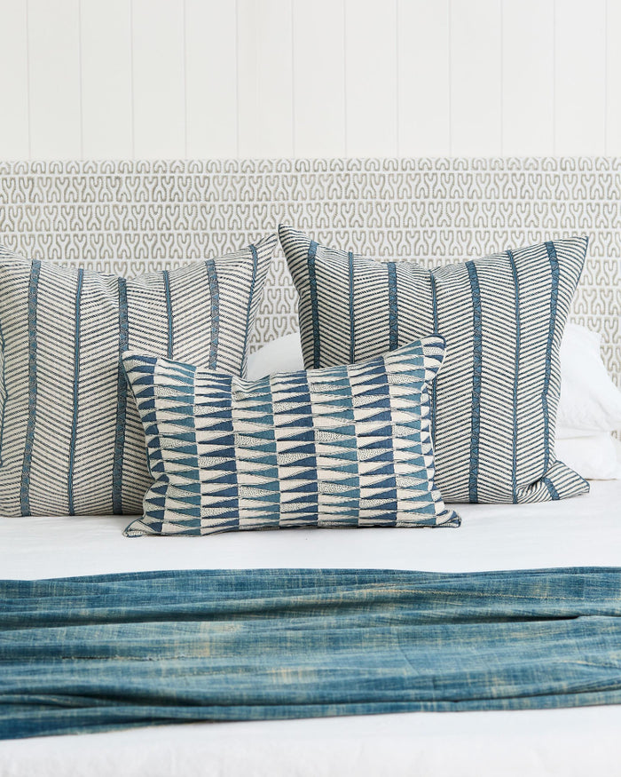 Tangier Denim Lumbar Pillow Cover styled on bed with Zanzibar Azure pillows
